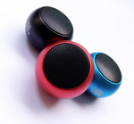 Three JBL portable Bluetooth speakers in black, red, and blue, arranged on a plain white background.